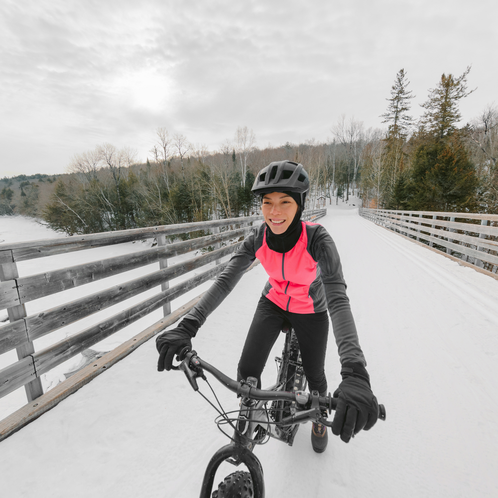 A girl riding a mountain bike in the winter