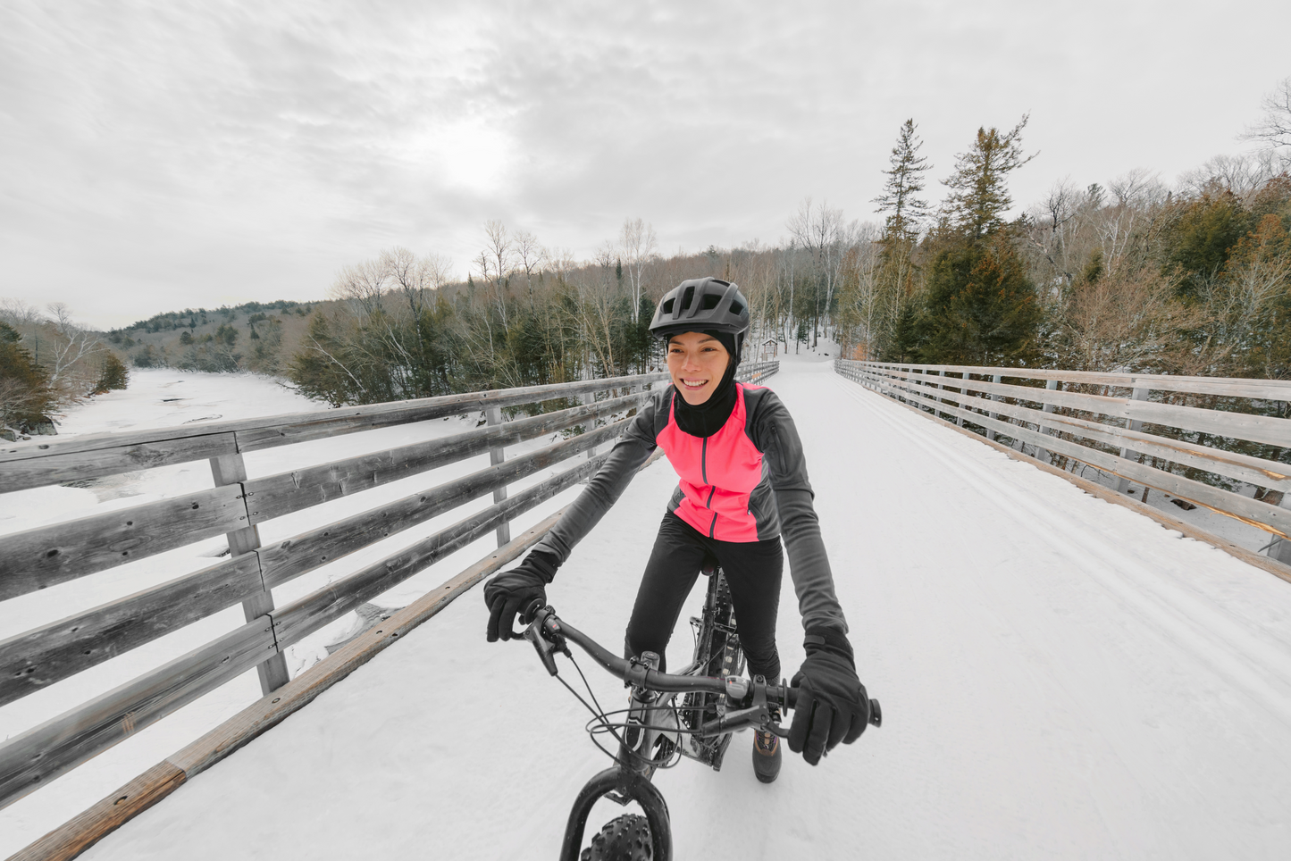 A girl riding a mountain bike in the winter
